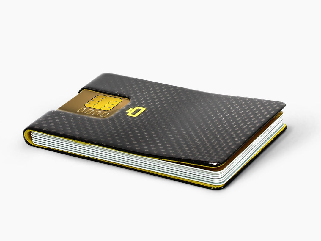 Side view of a carbon fiber card clip, showing its slim profile and high-gloss finish.