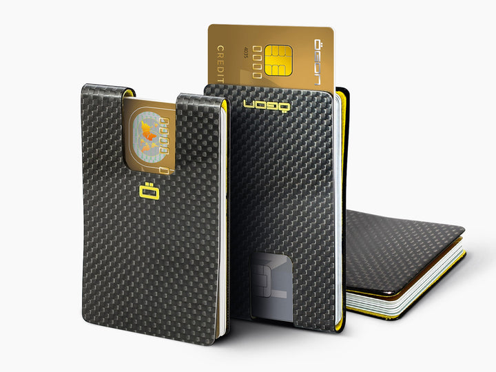 Two carbon fiber RFID blocking card clips, one standing with a card inserted and the other laying flat.