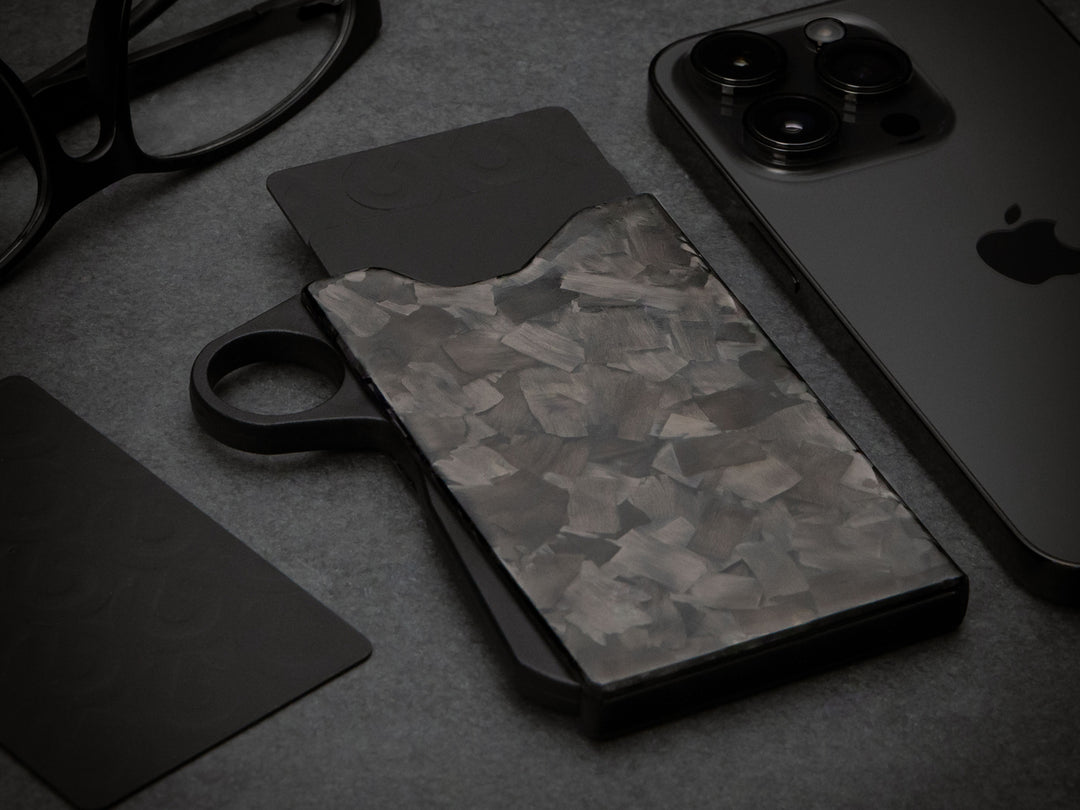 Grip6 forged carbon fiber wallet with loop on black background