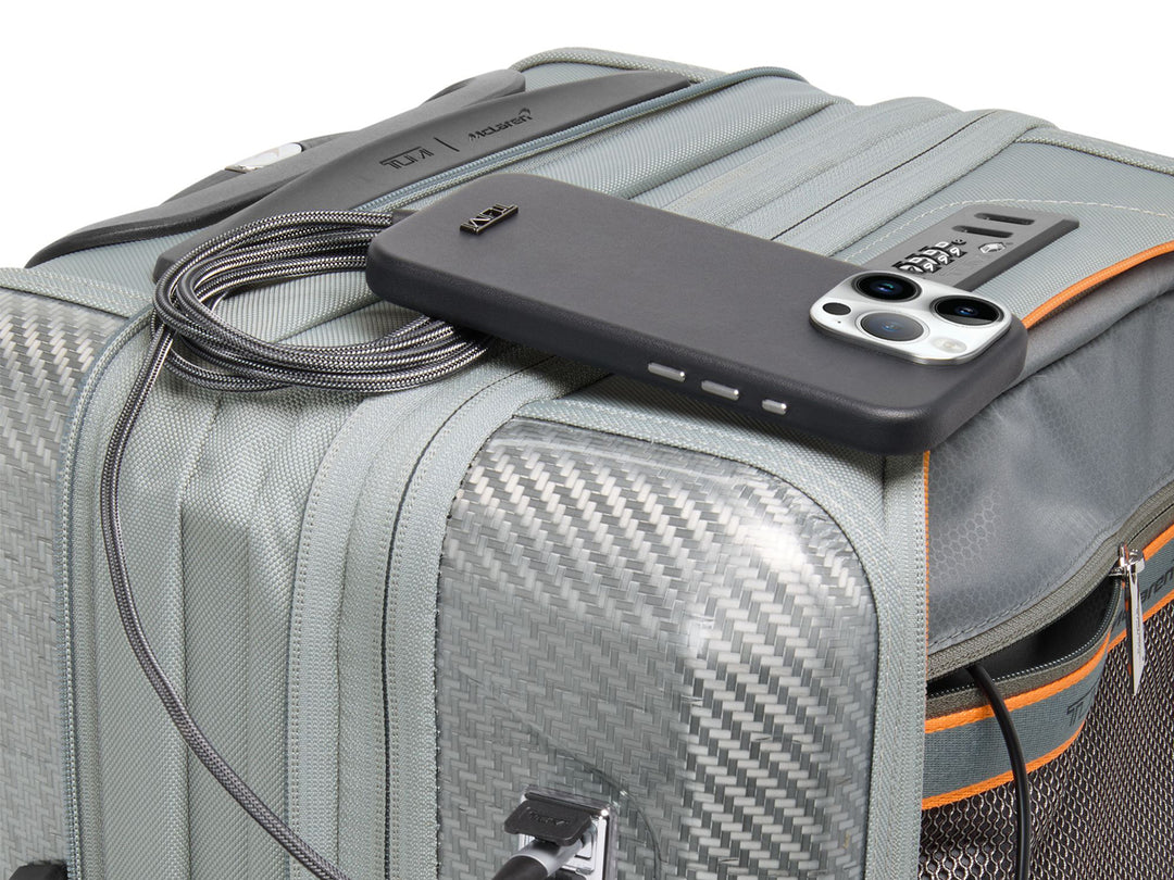 Detail shot of USB charging port, Papaya accents, and carbon fiber weave pattern