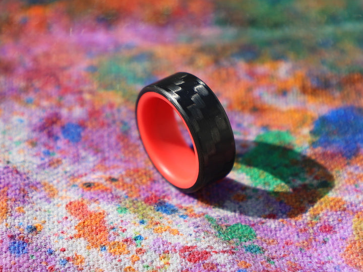 Red racer carbon fiber glow ring on painted canvas